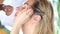 Hands of makeup artist plucked eyebrows