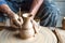 Hands of making clay pot on the pottery wheel ,select focus, close-up.