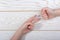 Hands making rock, paper, scissors gesture on wooden background