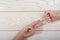 Hands making rock, paper, scissors gesture on wooden background