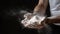 Hands of a male baker holding flour, preparing to make fresh dough for baking. Generative AI