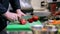 Hands of male chef chopping tomatoes in kitchen