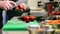 Hands of male chef chopping tomatoes in kitchen