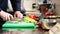 Hands of male chef cook chopping celery in kitchen