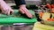 Hands of male chef cook chopping garlic in kitchen