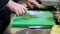 Hands of male chef cook chopping garlic in kitchen