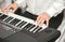 Hands of male musician playing at synthesizer. Mens arms plays solo of music or new melody. Close up fingers of pianist at the