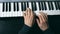 Hands of male musician playing at synthesizer. Mens arms plays solo of music or new melody. Close up fingers of pianist