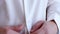 Hands of man buttoning buttons on a white shirt. man wearing white shirt, close-up