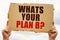 In the hands of a man is a cardboard sign with the inscription - Whats Your Plan B