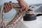 Hands of a man coiling up a rope, the halyard on a sailboat