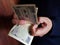 hands of a man counting Japanese banknotes