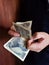 hands of a man counting Japanese banknotes