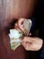 hands of a man counting peruvian banknotes