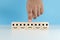 hands of man finger pointing selection wooden cube blocks with unhappy emotion icons blue background.