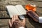 Hands of a man holding compass ready to write in open notebook