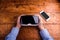 Hands of man holding virtual reality goggles and smartphone