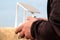 Hands of a man on the joystick control panel of an unmanned aerial vehicle. The farmer manages the drones over the field with a wh