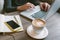 Hands of man on laptop with coffee and smartphone with notepad