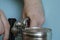 Hands of a man opens a tin can with a can key