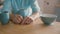 Hands of a man playing with his wedding ring at the kitchen table. Slow motion