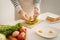 Hands of man prepare sandwich at home