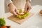 Hands of man prepare sandwich at home