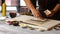 Hands of man preparing sushi.