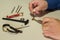 hands of a man while repairing watches. Watchmaker at work