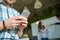 Hands of man using mobile phone while his partners arguing