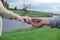 Hands of man and woman reaching to each other. Soft, gentle touch of hands on background of nature. Be hand in hand