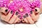 Hands with manicure and pink flower