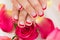 Hands With Manicured Nail Varnish Placed On Roses