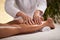 Hands massaging female calf