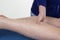 Hands massaging human calf muscle. Female therapist applying pressure on male leg.