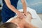 Hands of masseur stretching spine of female client in spa