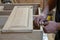 hands of a master carpenter install the hinges on the cabinet. Production of handmade wooden furniture.