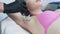 Hands of the master make laser epilation of the armpit area