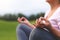 Hands of mature woman practicing yoga