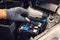 The hands of the mechanic replacing fuse in car and selects the correct fuse at garage .service and maintenance concept .