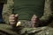 Hands of a military man in camouflage uniform in handcuffs, giving evidence during interrogation.