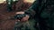 Hands military man holding walkie talkie closeup. Military radio in arm