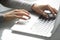 Hands of millennial businesswoman typing on laptop computer keyboard