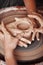 Hands molding shape on the pottery workshop