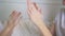 hands of mom and daughter play palms on the bed in the bedroom.