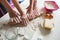 Hands Of Mother And Daughter Rolling Pizza Dough With Rolling Pin