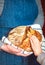 Hands of mother and daughter touching a loaf of freshly baked rustic bread. Concept of family and healthy food