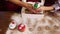 Hands of mother and her daughter put amazing Christmas cupcakes into the box.