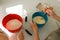 Hands of mother mixing batter while teaching to daughter