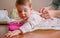 Hands of mother wearing her baby lying down